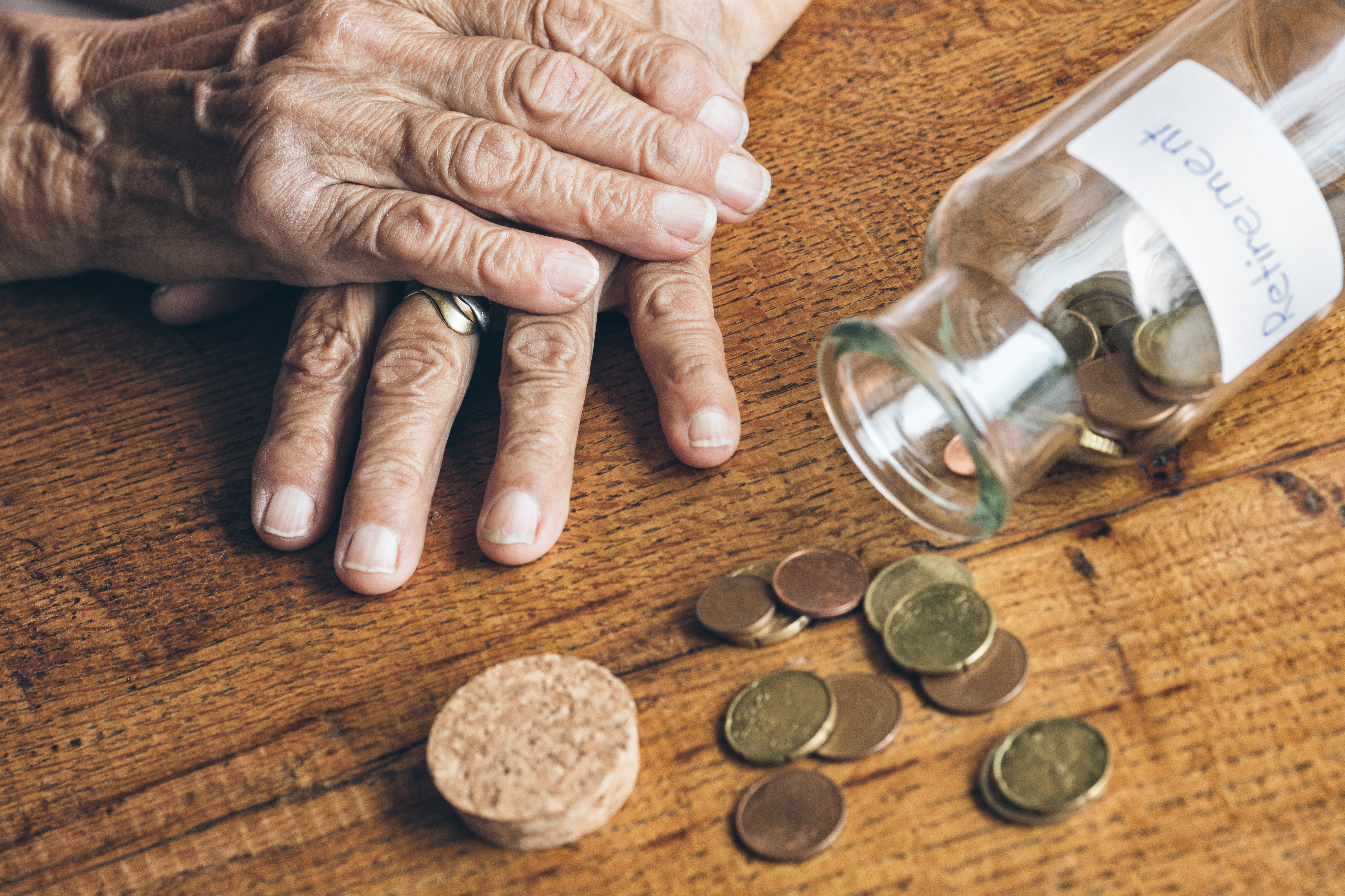 Senior woman's retirement savings in a jar