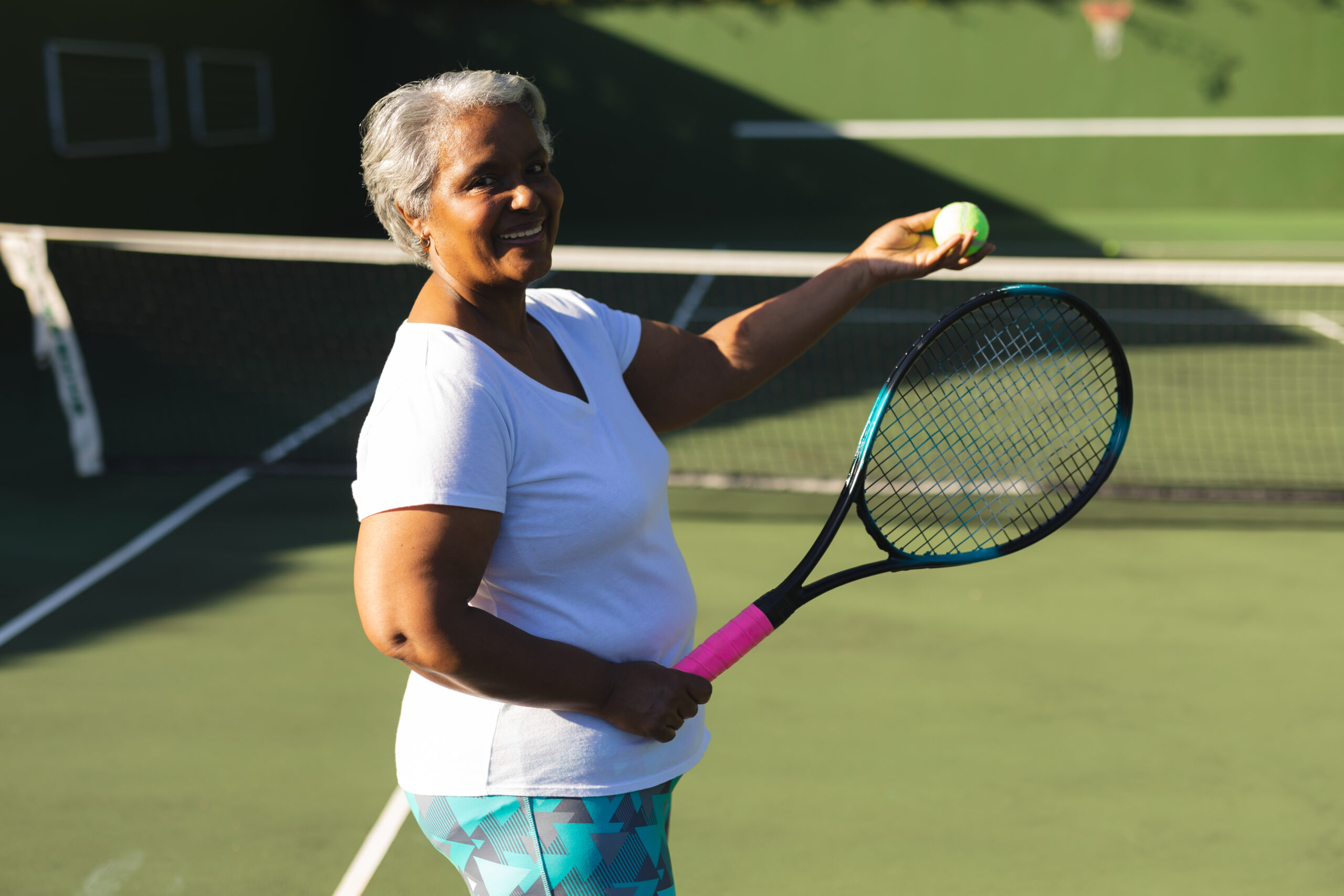 Older woman holding tennis racket