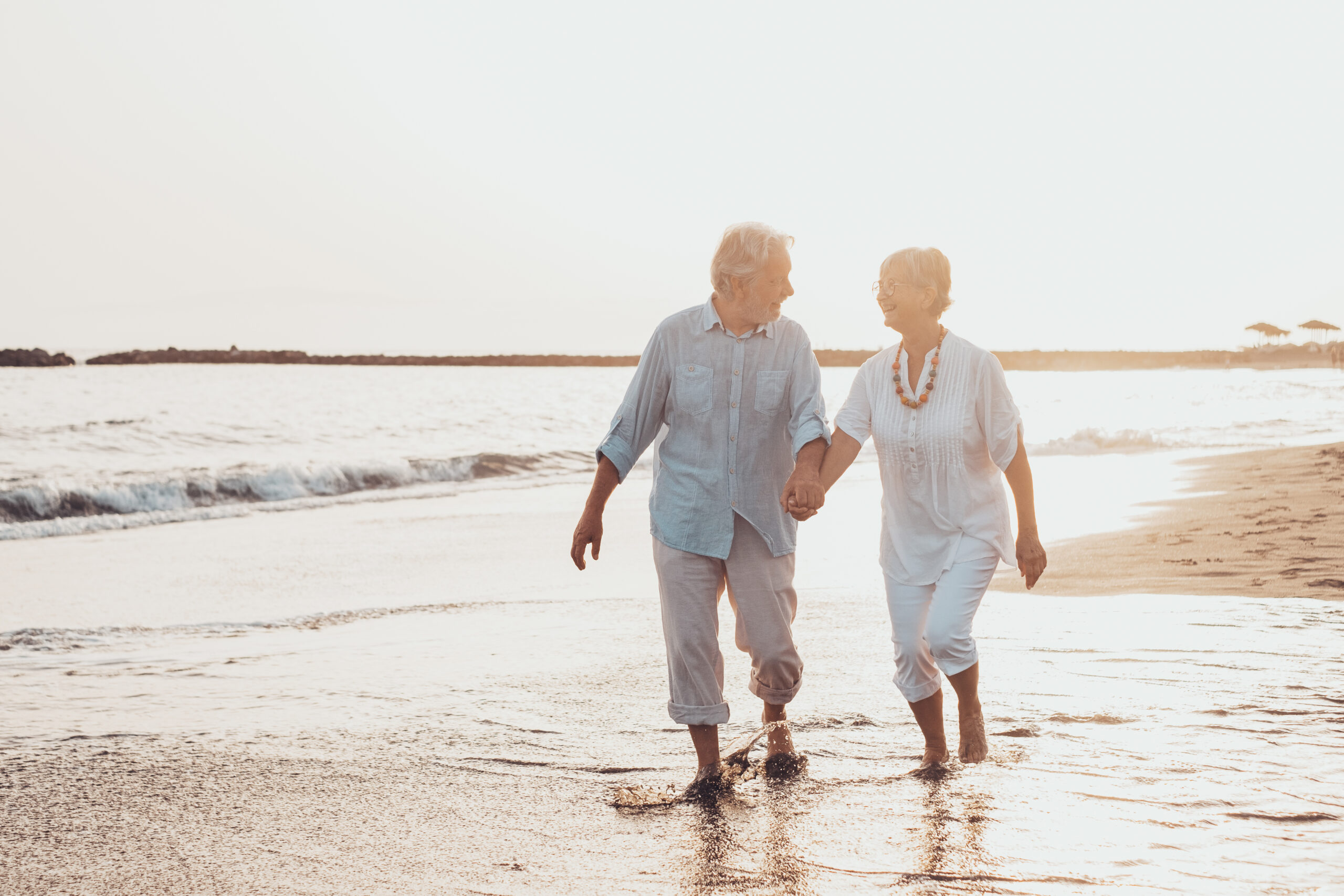 Older couple walking on the beach