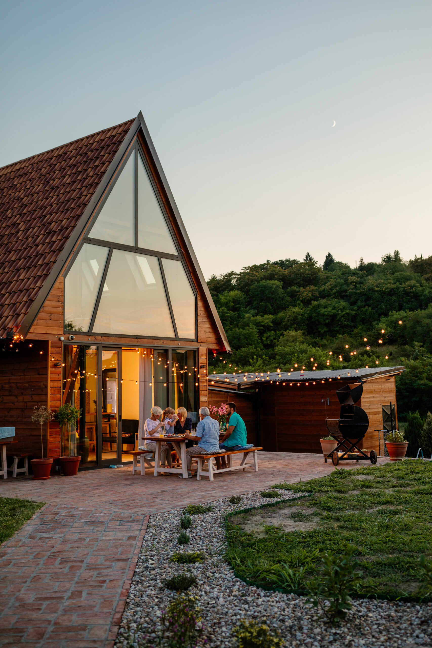 Family having dinner outside a cabin.